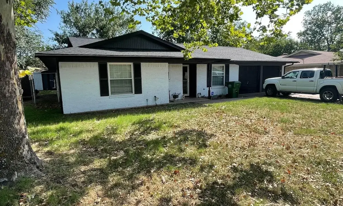 Professional roofing crew working on a residential roof in Charlestown